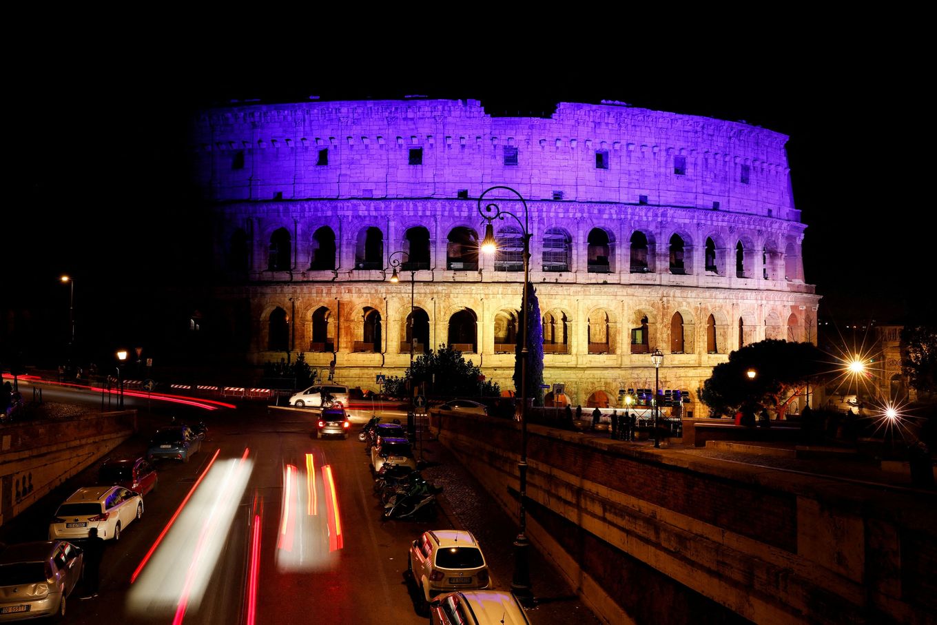 The Colosseum in Rome is lit up in the colors of the Ukrainian flag to mark the first anniversary of Russia's invasion of Ukraine on Friday. (Remo Casilli/Reuters)