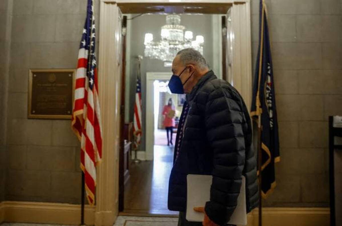 Senate Majority Leader Chuck Schumer (D-N.Y.) walks past the Senate Minority leader's office as he leaves the U.S. Capitol building on the eve of the first anniversary of the January 6, 2021 attack (Reuters/Evelyn Hockstein)