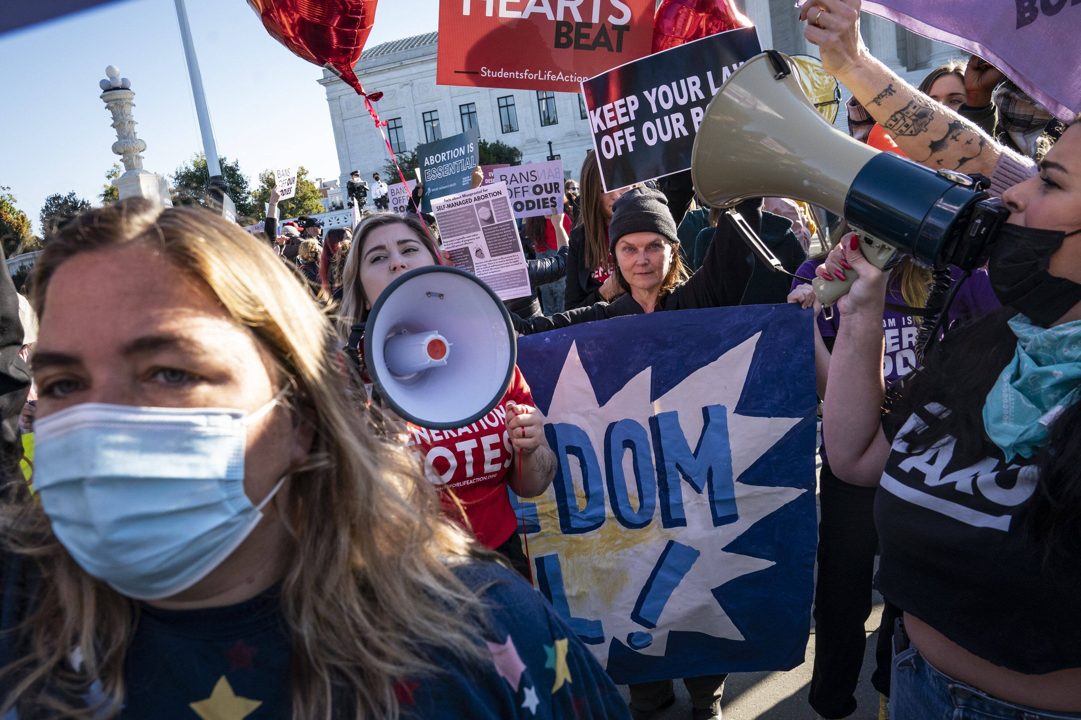 Abortion rights activists and antiabortion protesters gather outside the Supreme Court on Nov. 1 as arguments begin regarding a restrictive Texas abortion law. (Jabin Botsford/The Washington Post)