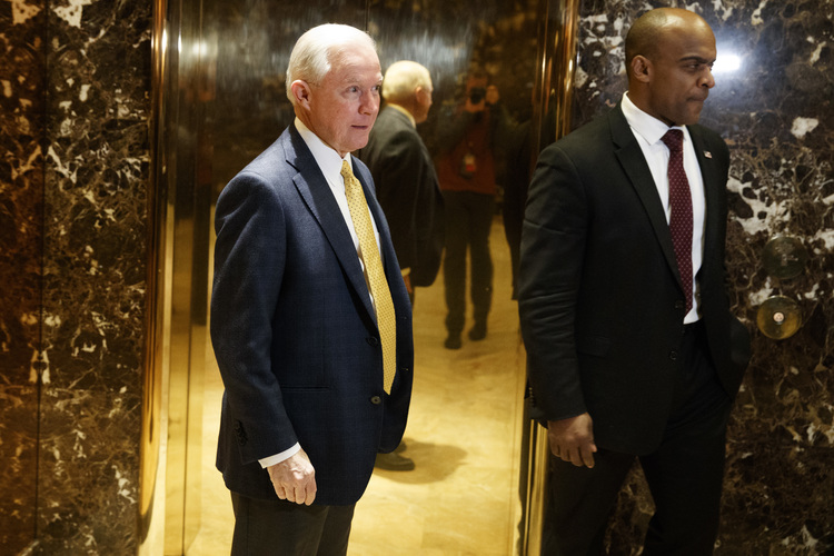 Jeff Sessions talks with reporters as he arrives at Trump Tower yesterday. (Evan Vucci/AP)</p>  