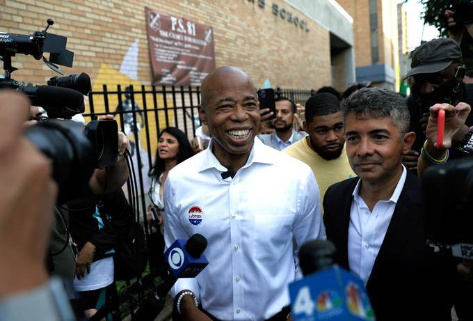 New York City mayoral candidate Eric Adams, center, greets supporters after voting on Election Day at P.S. 81 in the Bedford-Stuyvesant section of Brooklyn. (Peter Foley/EPA-EFE/Shutterstock)