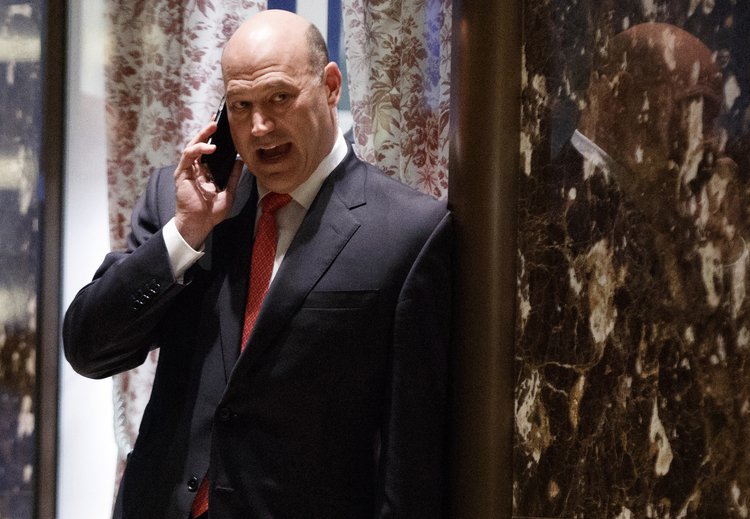 Goldman Sachs COO Gary Cohn talks on his phone as he waits for the start of a meeting with Trump at Trump Tower. (Evan Vucci/AP)</p>  