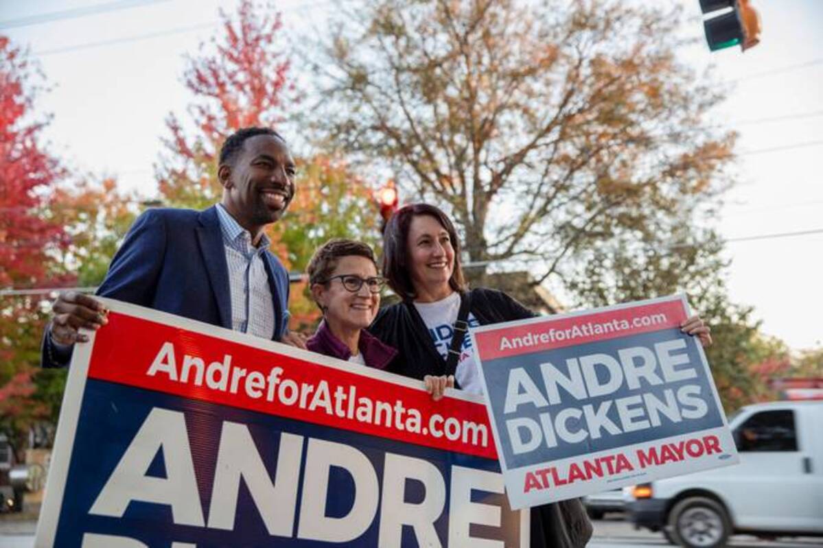 Atlanta mayoral candidate Andre Dickens campaigns with his supporters Jenifer Keenan and Karri Hobson-Pape on Election Day in Atlanta. (Alyssa Pointer/Reuters)