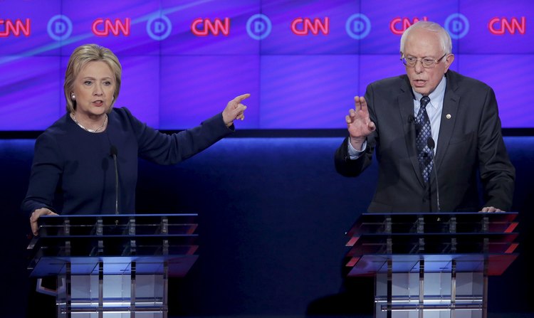 Hillary Clinton and Bernie Sanders speak simultaneously during their debate in Flint, Michigan on&nbsp;March 6.&nbsp;(Jim Young/Reuters)</p>  