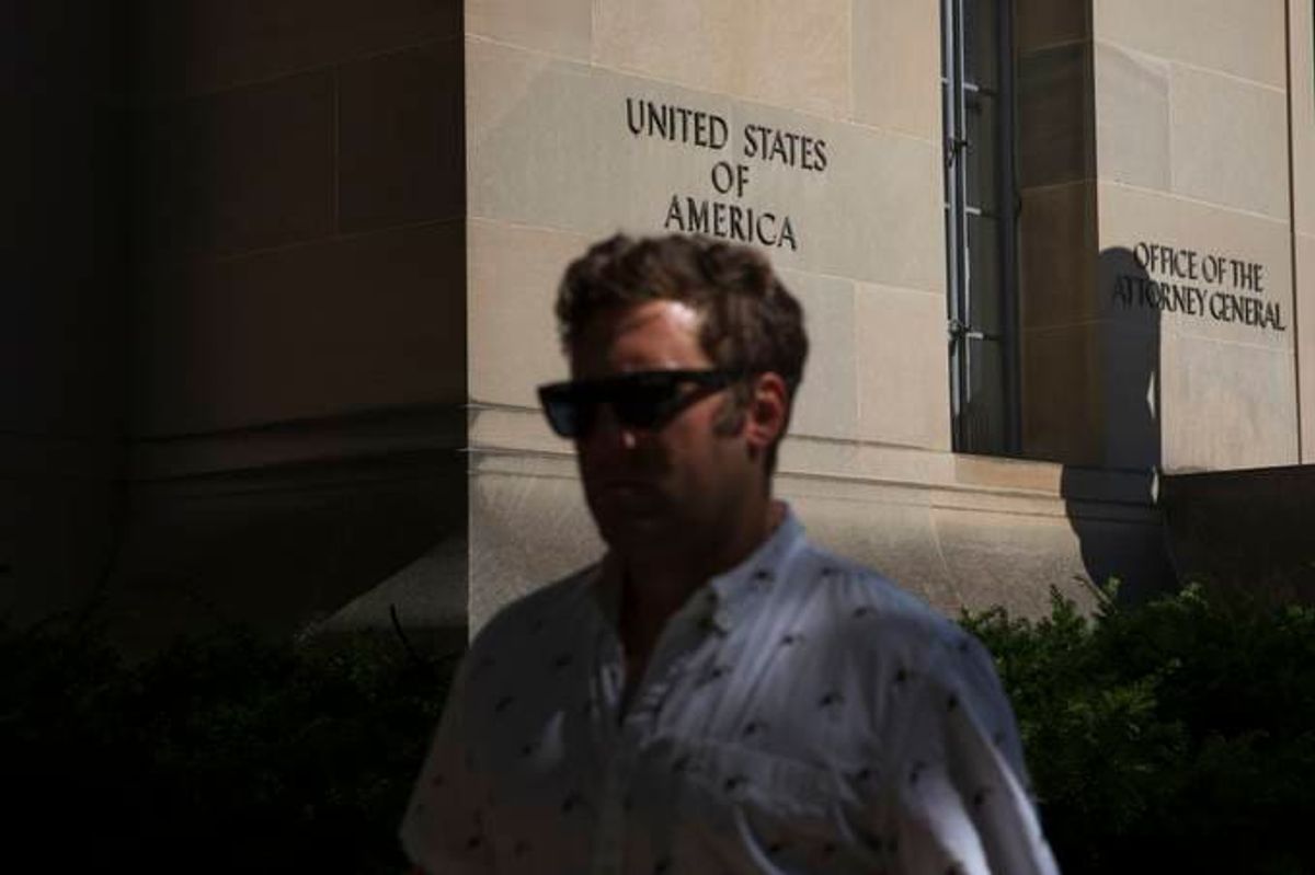 A pedestrian walks past the Justice Department in D.C. (Tom Brenner for The Washington Post)