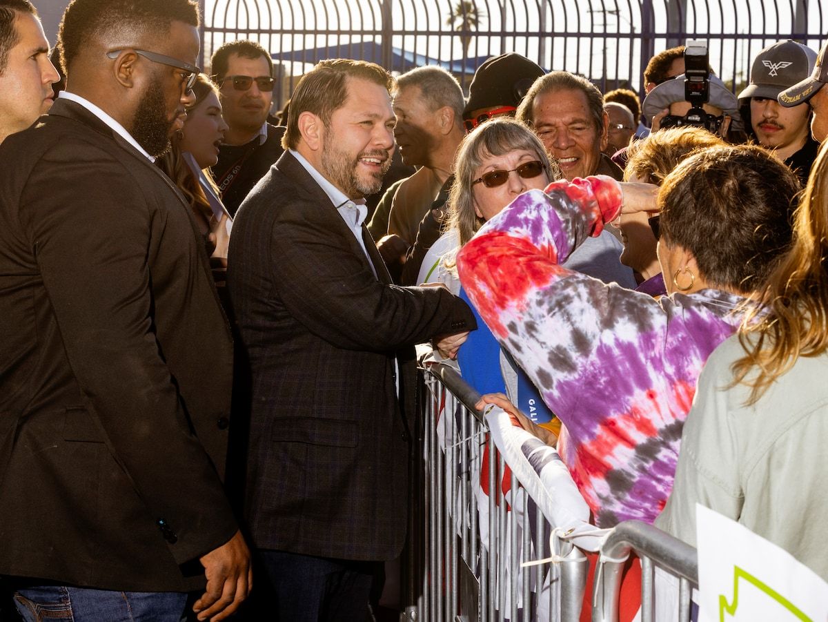 Rep. Ruben Gallego (D-Ariz.) meets supporters at a campaign event at Grant Park in Phoenix on Saturday. (Cassidy Araiza for The Washington Post) 
