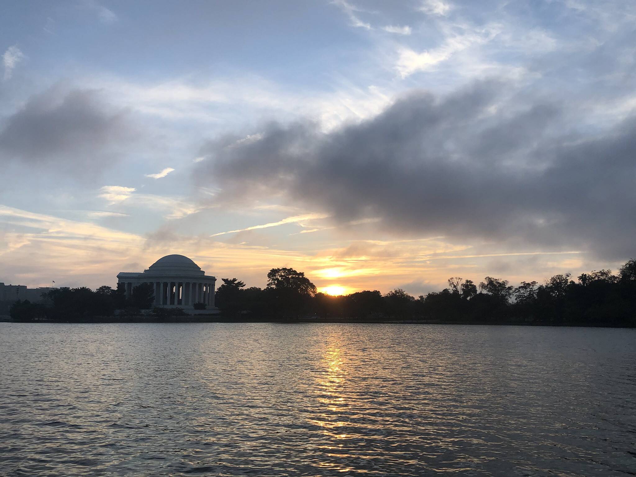 Blue sky and clouds Thursday as the sun rises over the Tidal Basin.
