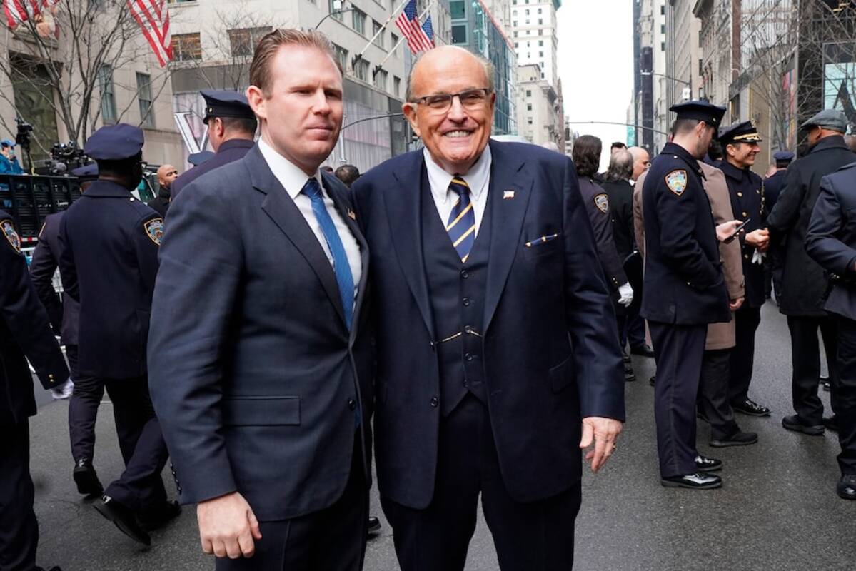 Rudy Giuliani and his son, Andrew, pose for a photo outside St. Patrick's Cathedral at the funeral of NYPD officer. (Catherine Nance/SOPA ImagesSipa USA/AP)
