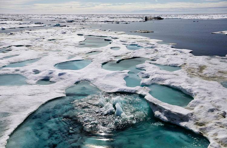 Ice is broken up by the passing of a ship sailing through the Beaufort Sea off the coast of Alaska. (David Goldman/AP)  