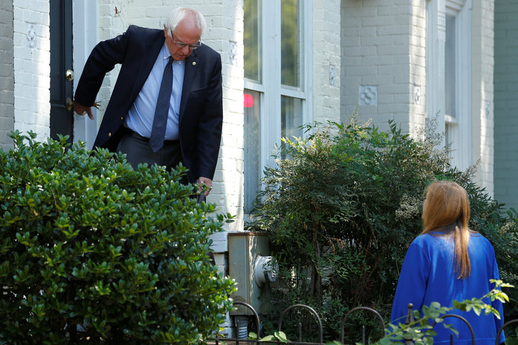 Bernie Sanders departs his Capitol Hill house yesterday to walk with his wife Jane to his campaign headquarters.&nbsp;(Reuters/Jonathan Ernst)</p>  