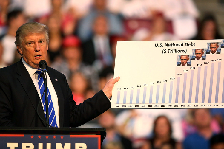 Trump holds up a chart as he speaks during his campaign event In Fort Lauderdale.&nbsp;(Joe Raedle/Getty Images)</p>  