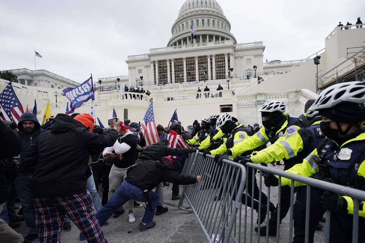 Supporters of then-President Donald Trump try to break through a police barrier at the U.S. Capitol in Washington on Jan. 6, 2021. (Julio Cortez/AP)