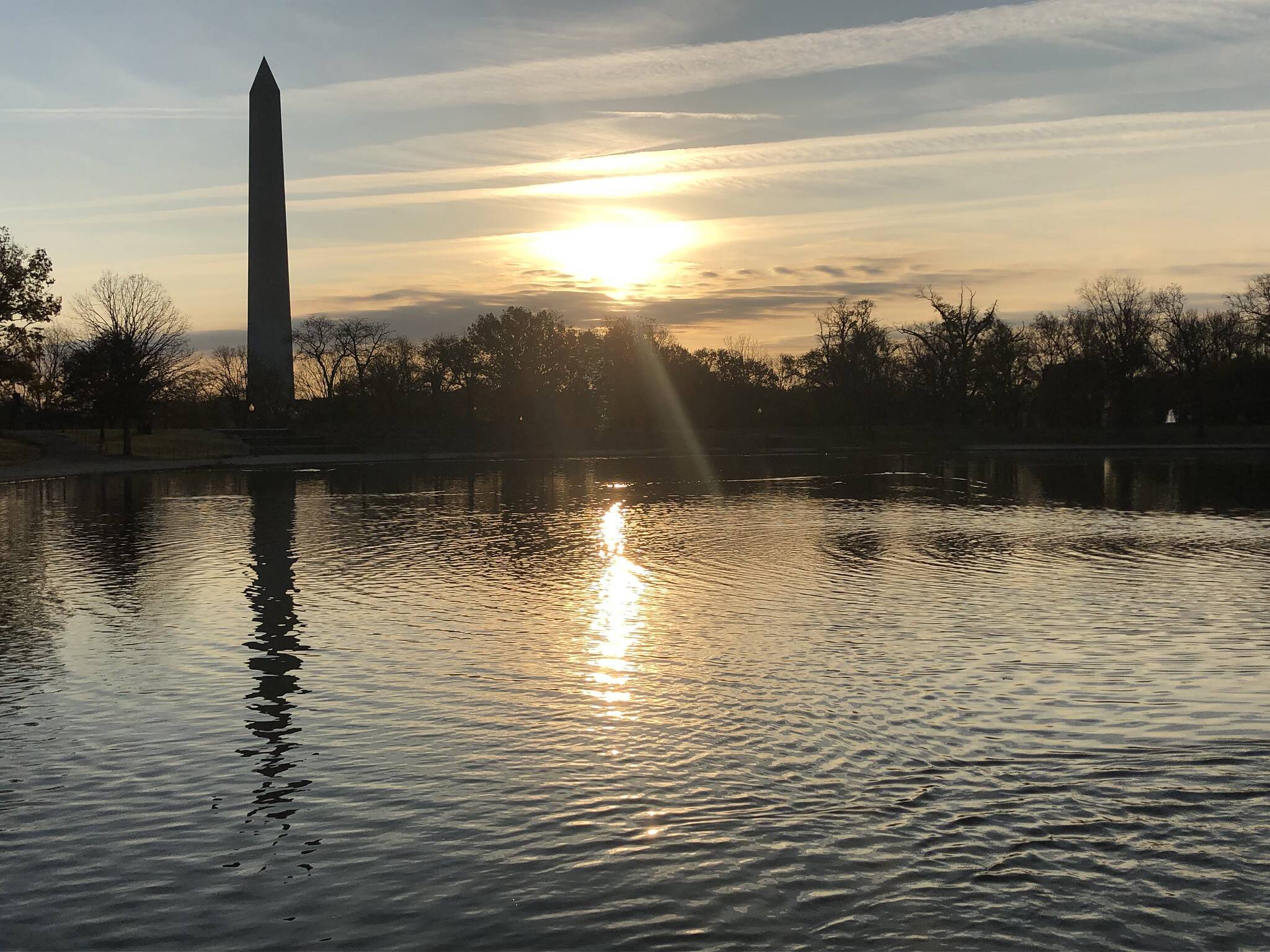 Blue sky and clouds on Saturday over Constitution Gardens as the sun rises in Washington, D.C.