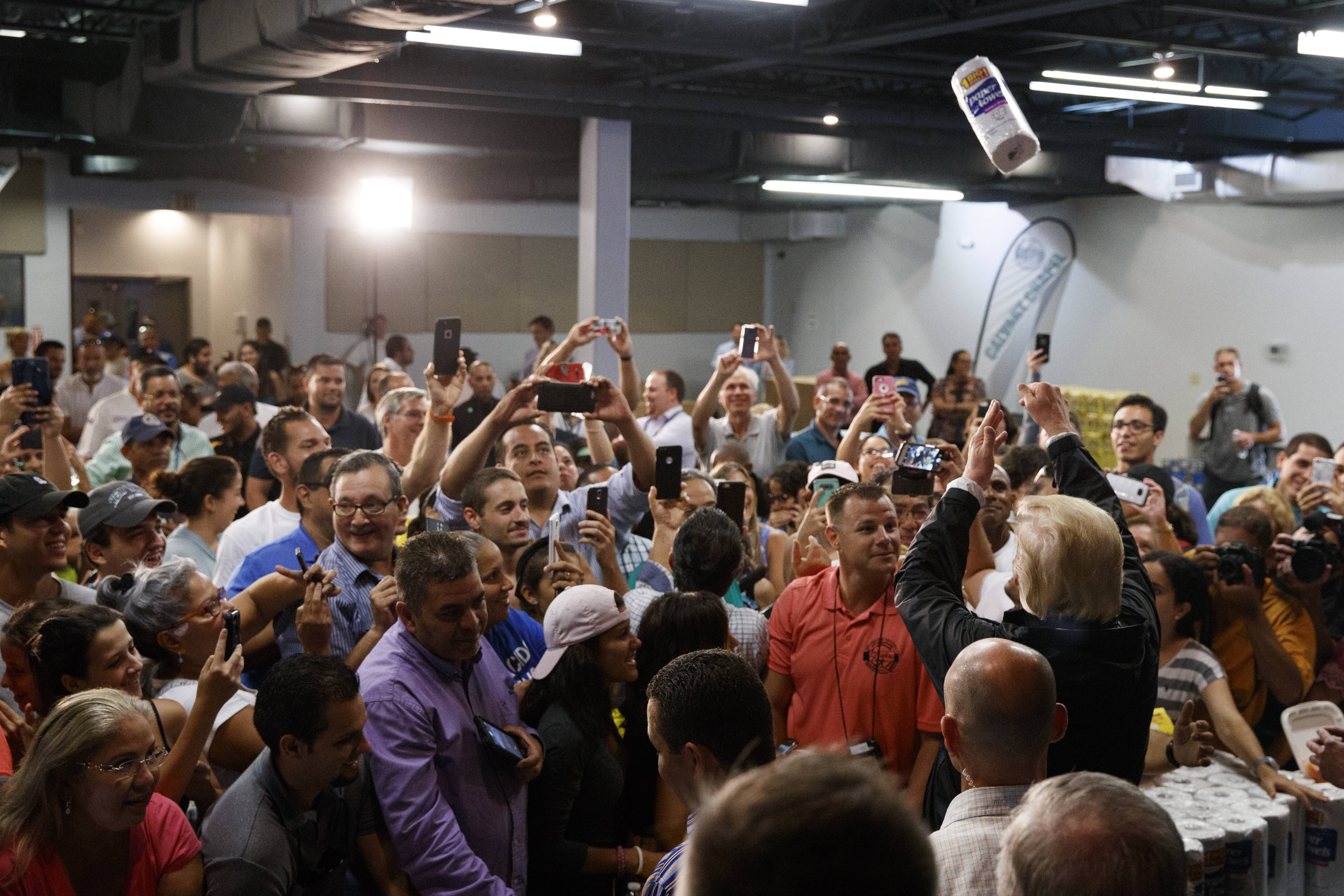 President Donald Trump tosses out paper towels in Puerto Rico in 2017 after Hurricane Maria hit the island. (AP Photo/Evan Vucci)