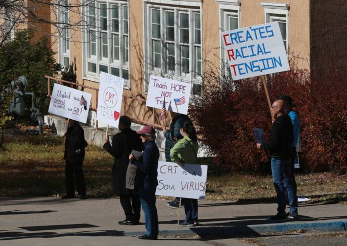 People protest outside the offices of the New Mexico Public Education Department's office, on Nov. 12, 2021, in Albuquerque (Cedar Attanasio/AP)