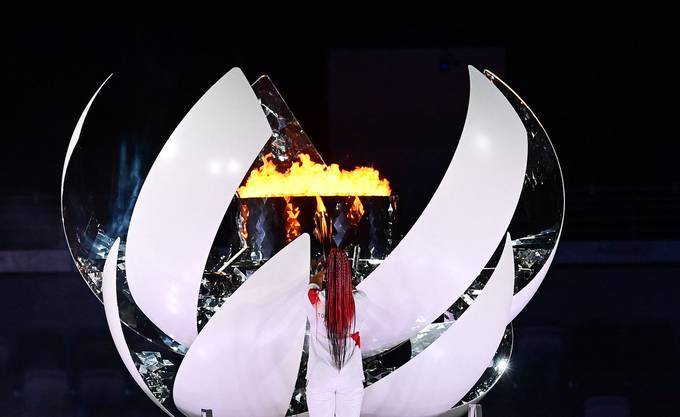 Japanese tennis player Naomi Osaka lights the flame of hope in the Olympic Cauldron during the opening ceremony of the Tokyo 2020 Olympic Games. (Franck Fife/AFP via Getty Images)