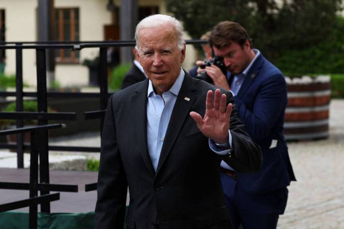 President Biden waves as he arrives with representatives of the seven rich nations (G-7) and Outreach guests to a working session about 