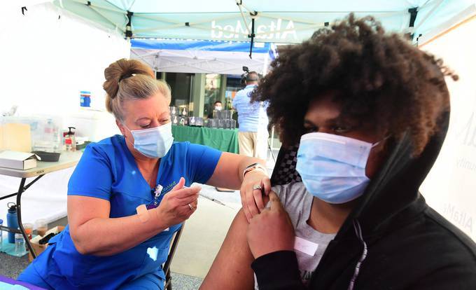 The Pfizer vaccine is administered in Los Angeles, California. (Photo by FREDERIC J. BROWN/AFP via Getty Images)