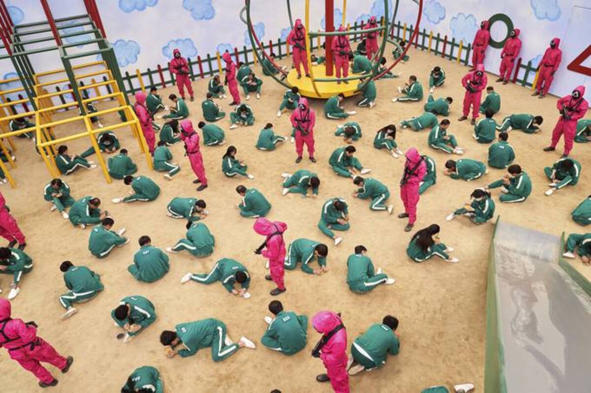 This undated photo released by Netflix shows a scene of contestants vying to win the Dalgona Korean candy challenge in a scene from "Squid Game." (Youngkyu Park/Netflix via AP)