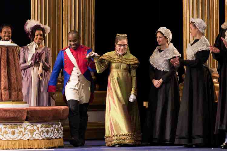 Tenor Lawrence Brownlee escorts Justice Ruth Bader Ginsburg at the curtain call of &ldquo;The Daughter of the Regiment.&rdquo; (Scott Suchman for the Washington National Opera)</p>  