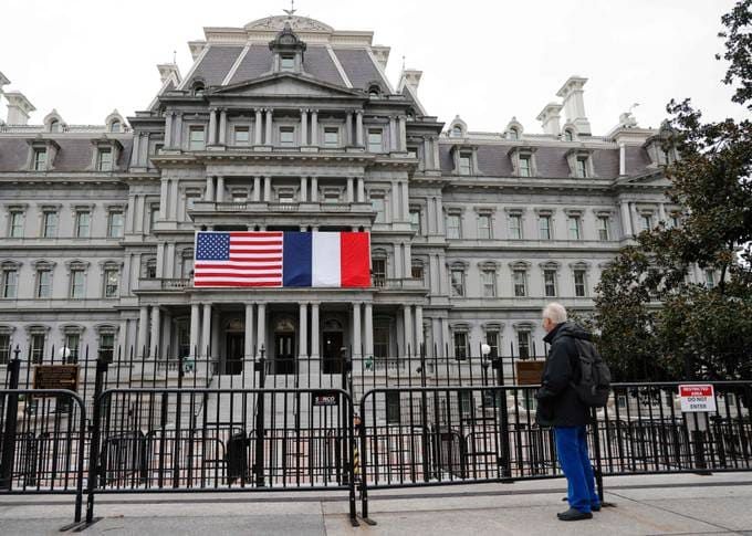 The French and U.S. flags adorn the Eisenhower Executive Office Building next to the White House on Tuesday. (Ludovic Marin/AFP)