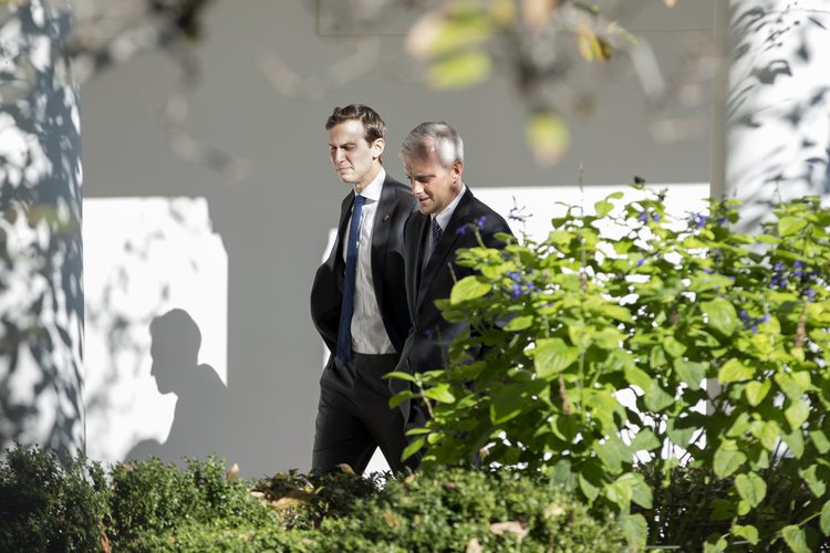 Jared Kushner walks with Denis McDonough around the White House grounds. (Michael Reynolds/EPA)</p>  