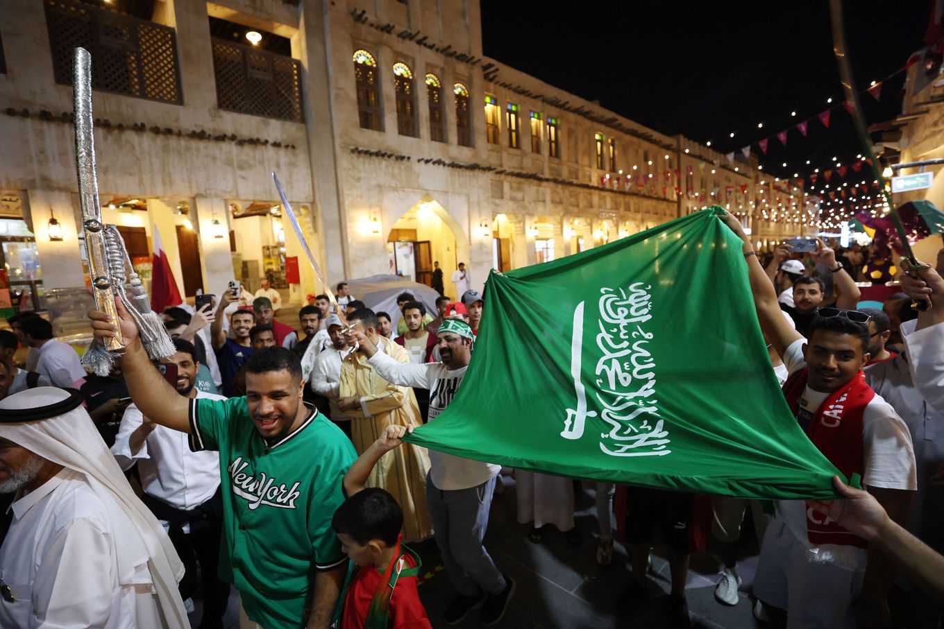 Fans celebrate and carry the flag of Saudi Arabia. (Amr Abdallah Dalsh/Reuters)