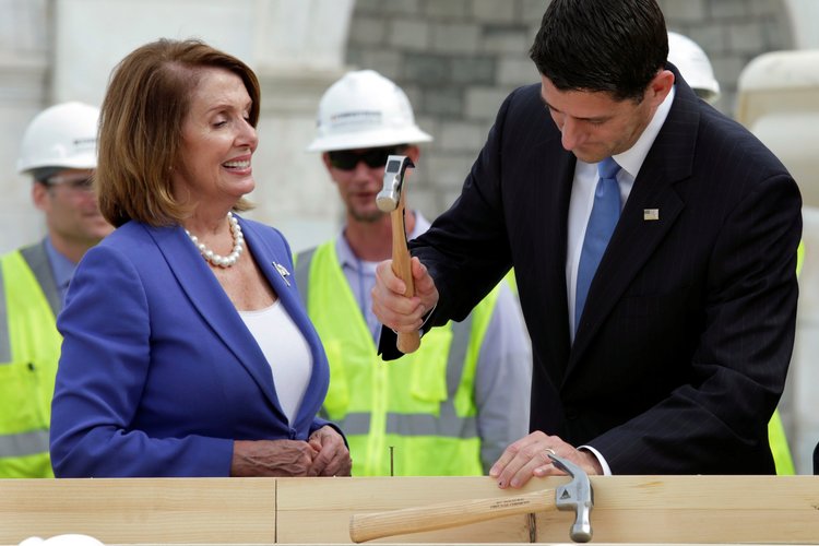 Paul Ryan and Nancy Pelosi participate in the "first nail ceremony" kicking off the construction of the Inauguration Platform on the West Front of the Capitol in September. (Yuri Gripas/Reuters)</p>  