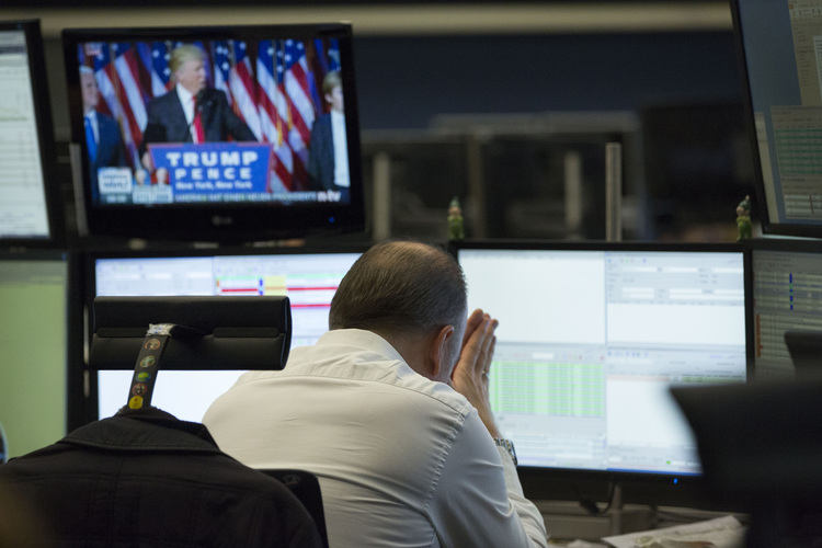 A trader in Frankfurt, Germany reacts as a television news report shows Trump speaking. (Alex Kraus/Bloomberg)</p>  