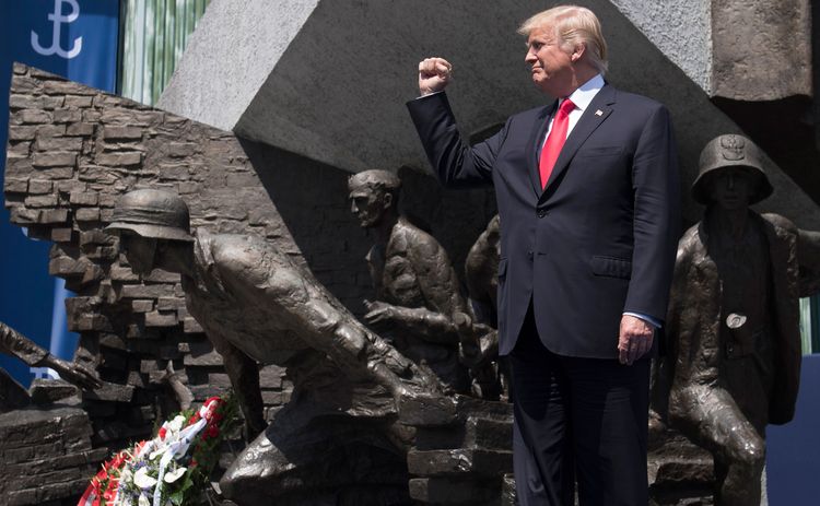 Donald Trump clenches his fist yesterday in front of the Warsaw Uprising Monument on Krasinski Square. (Saul Loeb/AFP/Getty Images)</p>  