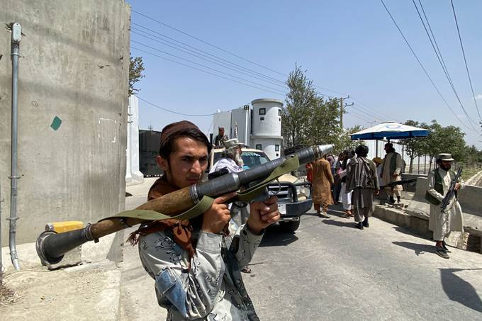 A Taliban fighter stands guard outside the Interior Ministry in Kabul on Aug. 17. (Javed Tanveer/AFP/Getty Images)