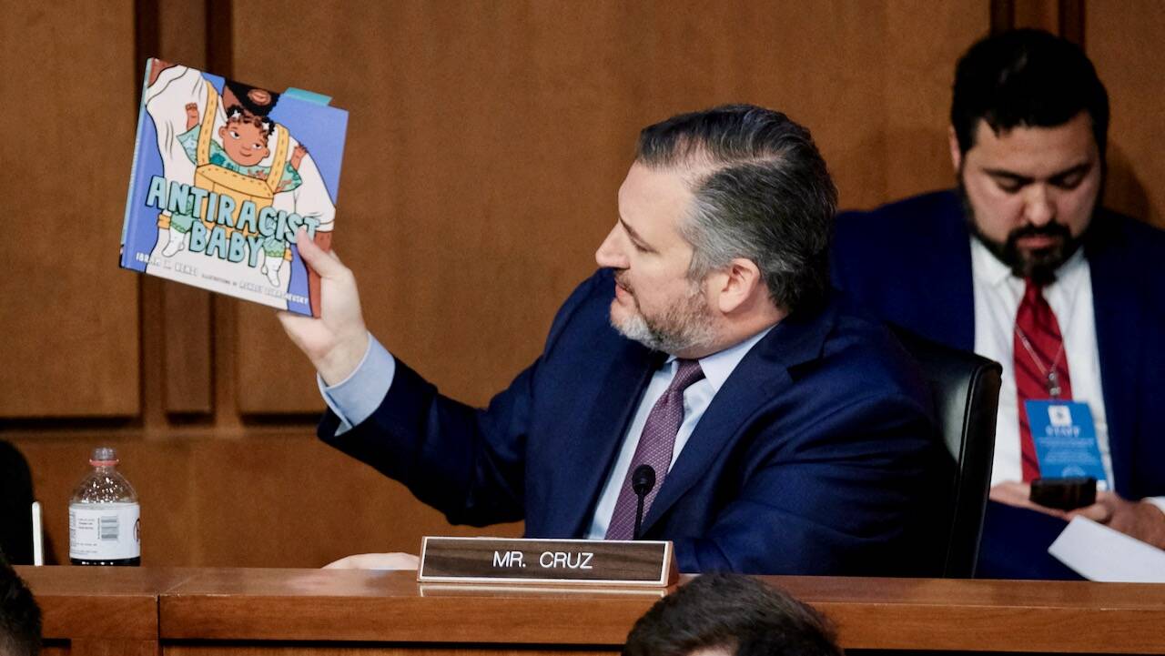 Sen. Ted Cruz (R-Tex.) holds up the children's book "Antiracist Baby," by Ibram X. Kendi, as he questions Supreme Court nominee Ketanji Brown Jackson on March 22 in Washington. (Michael Mccoy/Reuters)