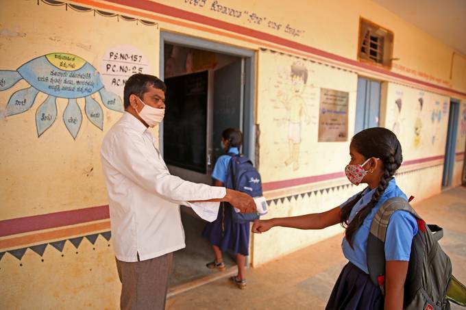 Students attend the first day of school following the ease of COVID-19 restrictions, at Government Model Primary School in Bangalore, India. (Jagadeesh NV/EPA)