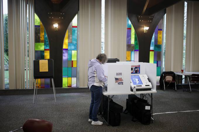 A voter casts a ballot inside a polling place at Ascension Lutheran Church in Columbus, Ohio, on Tuesday. (Luke Sharrett/Bloomberg)