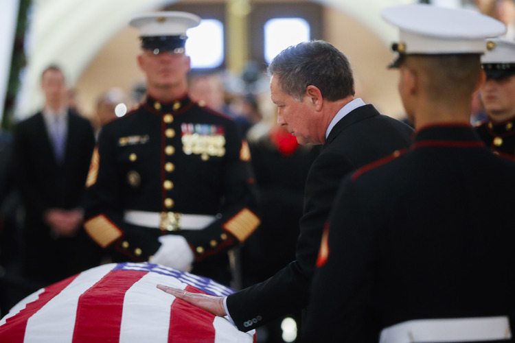 Trump is trying to get back at John Kasich, seen here touching the casket of John Glenn last month, for not endorsing him. (<span style="font-size:1rem">John </span>Minchillo/AP<span style="font-size:1rem">)</span></p>