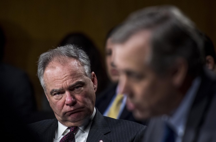 Tim Kaine listens to Jeff Merkley question Rex Tillerson. (Melina Mara/The Washington Post)</p>  