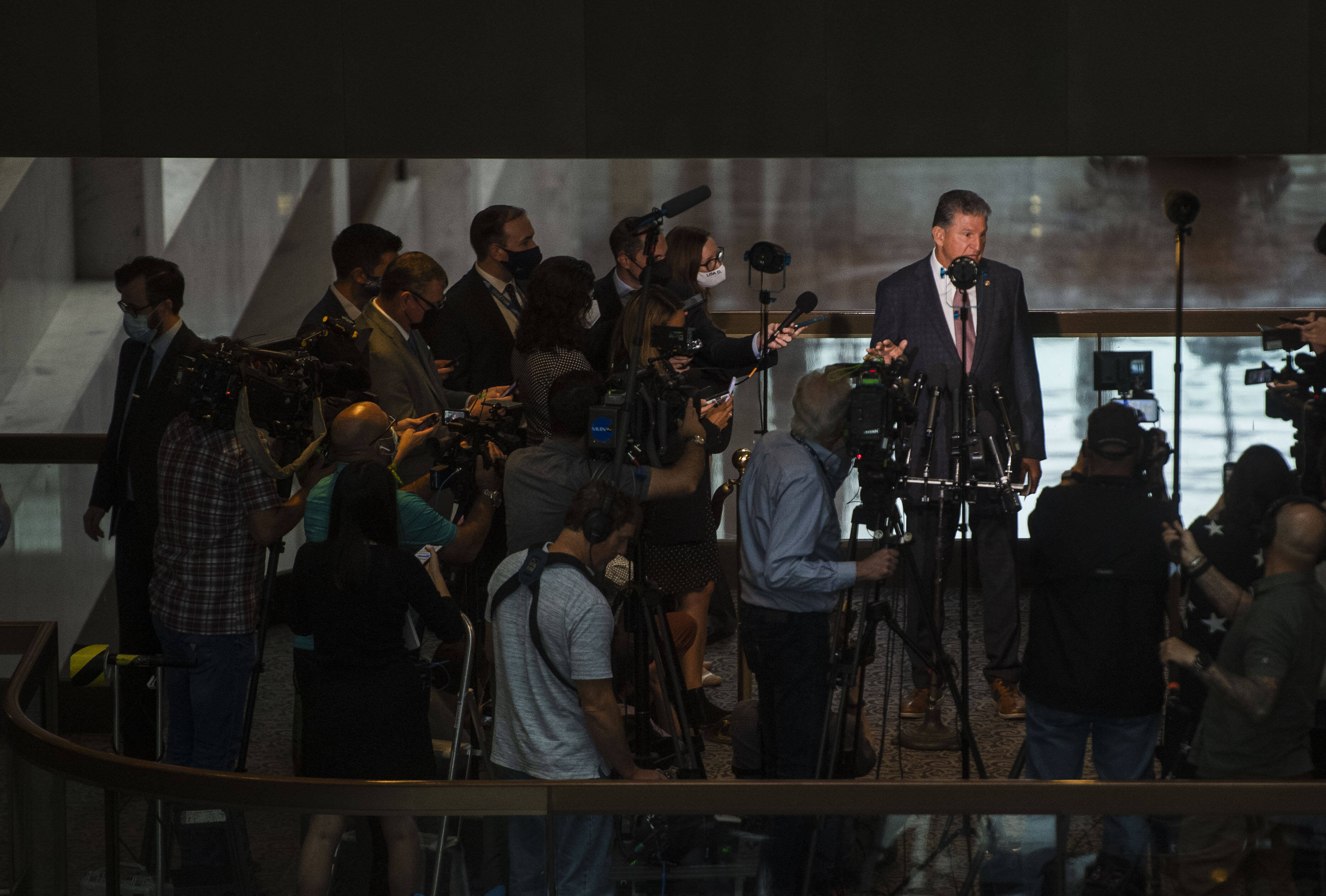Sen. Joe Manchin III (D-W. Va.) talks to reporters Wednesday about his opposition to changing the filibuster. (Amanda Voisard/for The Washington Post)