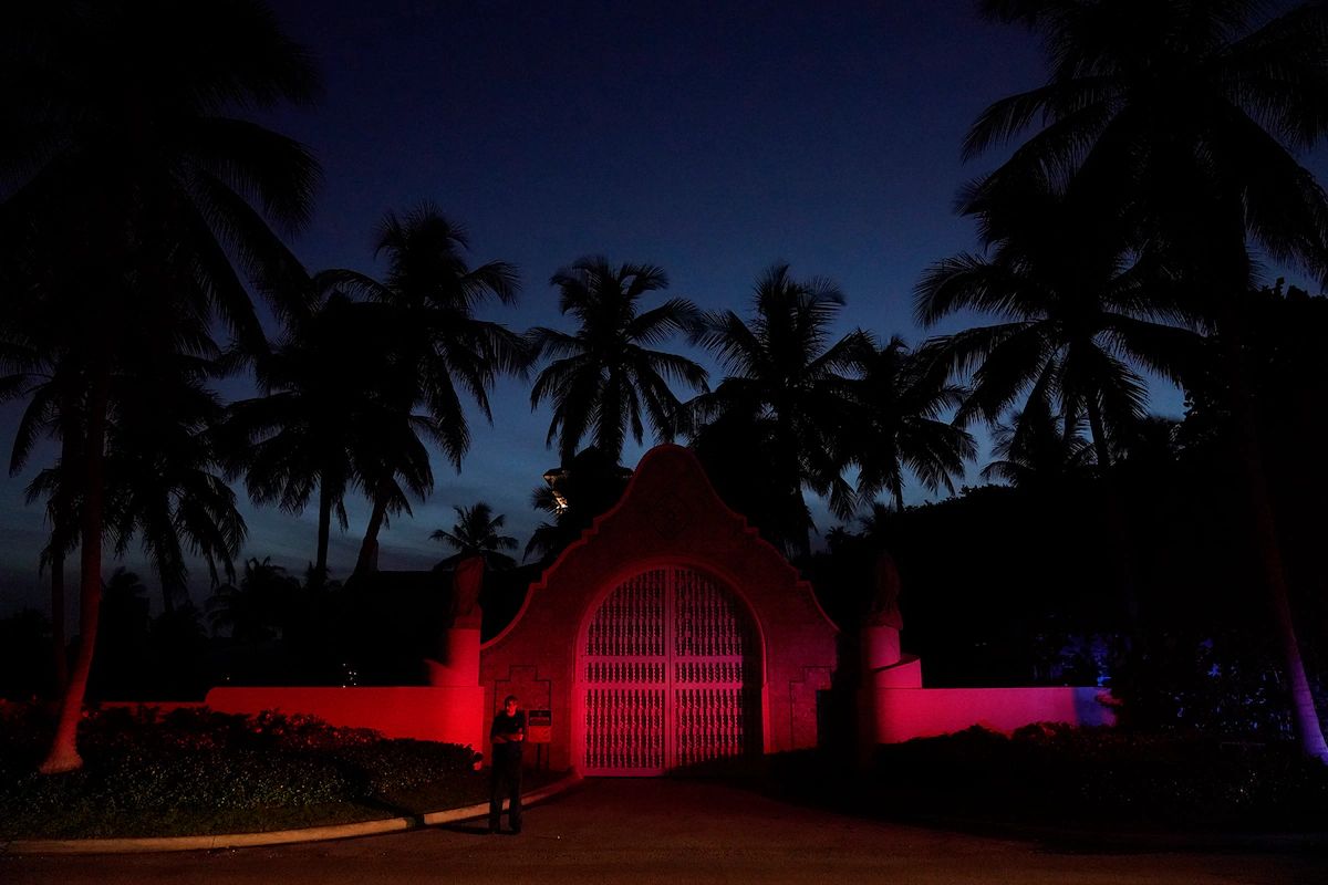 A man stands outside an entrance to former president Donald Trump's Mar-a-Lago estate on Aug. 8, 2022, in Palm Beach, Fla. (Wilfredo Lee/AP)