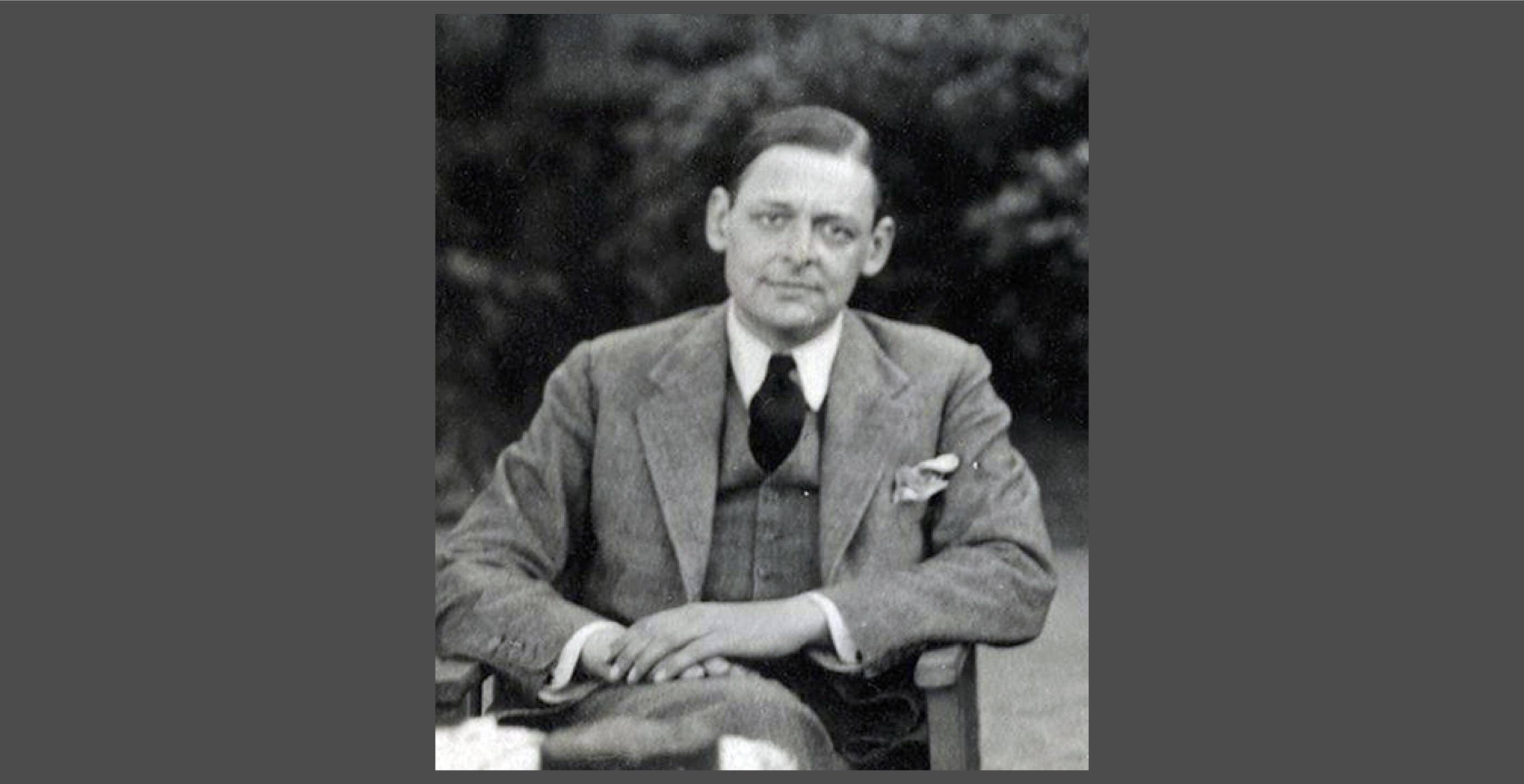 T.S. Eliot in 1934. You can't tell from this photo, but he's wearing the bottoms of his trousers rolled. (Photo by Lady Ottoline Morrell)&nbsp;