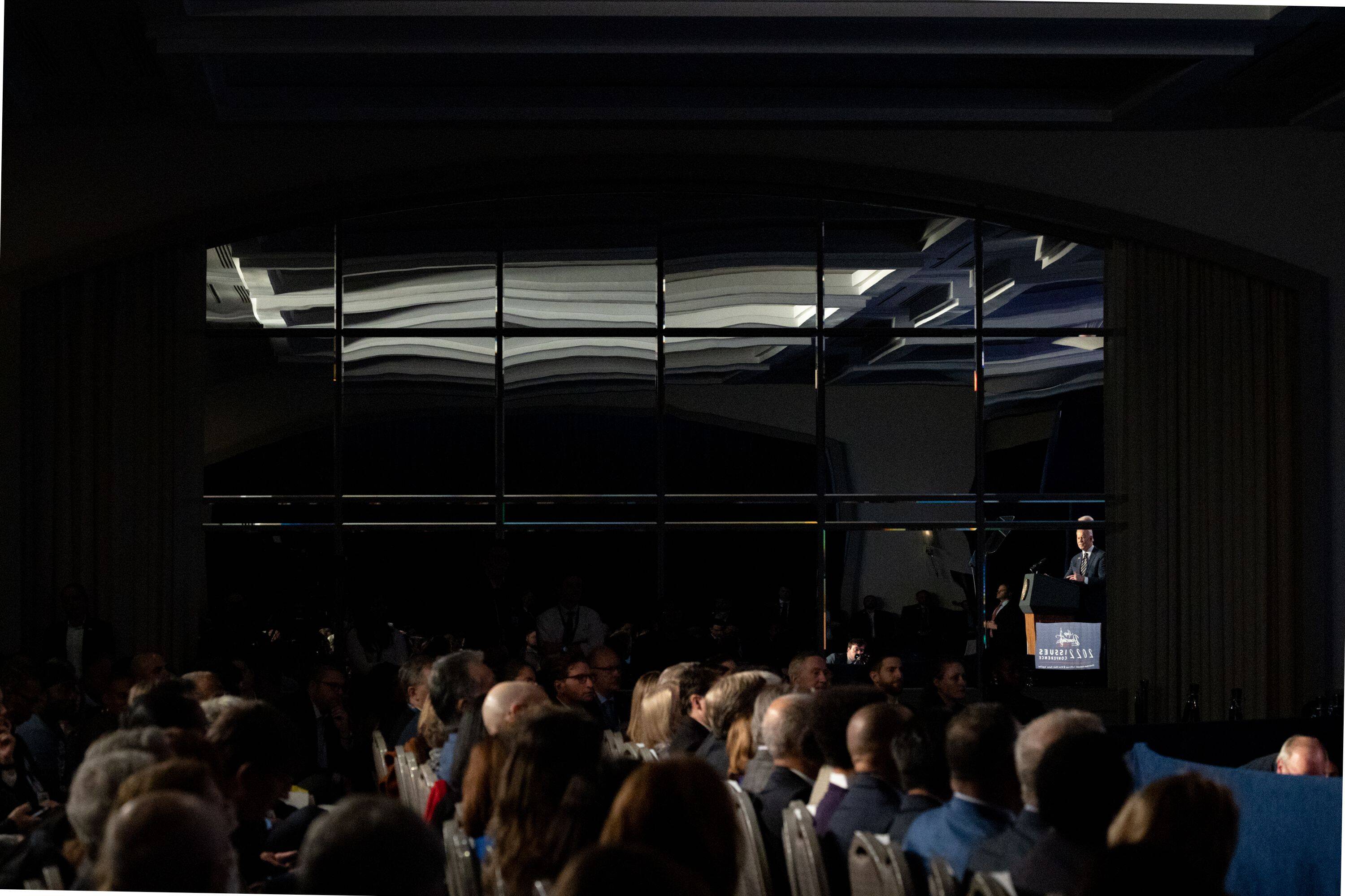 President Biden, right, is reflected in a mirror while speaking during the House Democratic Caucus Issues Conference meeting in Philadelphia on March 11. (Hannah Beier/Bloomberg News)