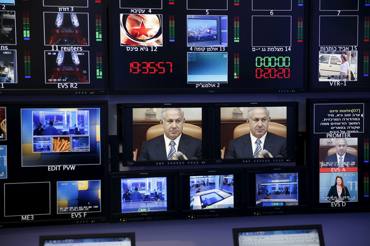 Benjamin Netanyahu is seen on monitors at Channel 10's control room in Jerusalem. (Reuters/Ronen Zvulun)</p>  