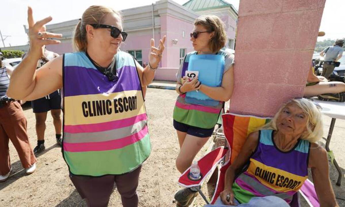 Clinic escorts stand outside Jackson Women's Health Organization, which is the only abortion clinic in Mississippi. (Rogelio V. Solis/AP)