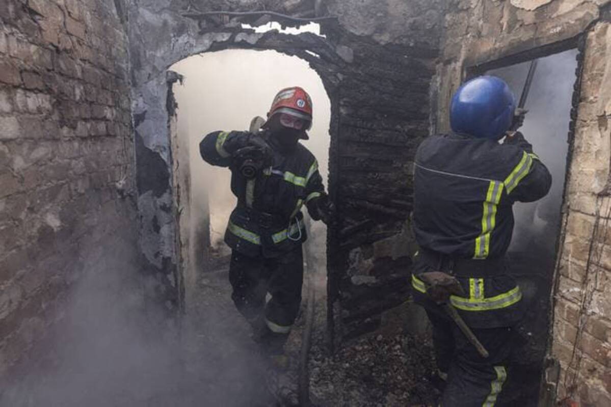 Firefighters work at a residential district damaged by shelling in Kyiv on Tuesday. REUTERS/Marko Djurica