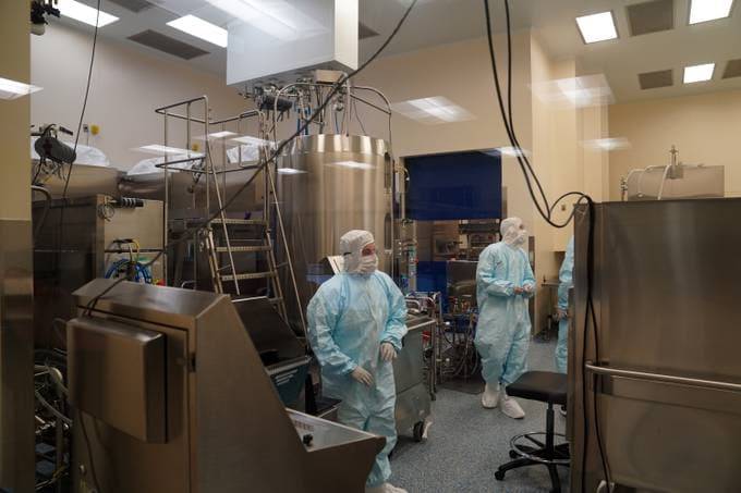 Employees work in a lab at Emergent BioSolutions. (Michael Robinson Chavez/The Washington Post)