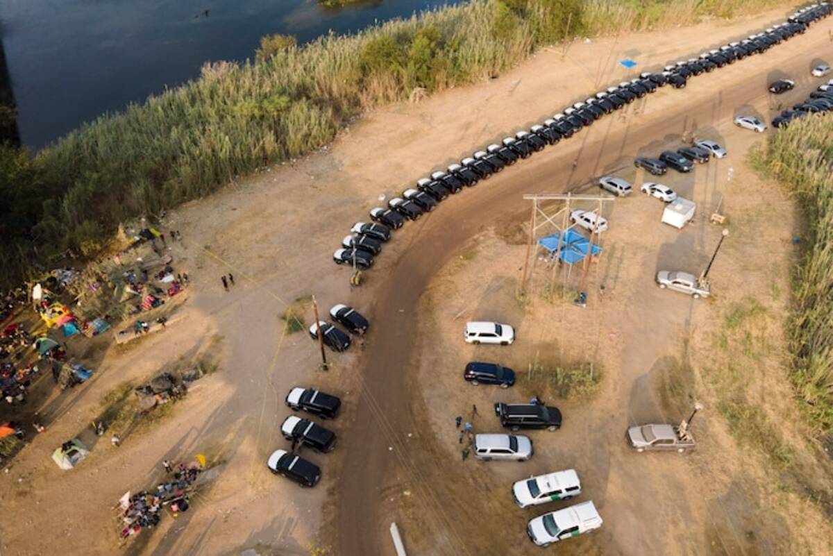 Texas Department of Public Safety vehicles line up along the bank of the Rio Grande Sept. 21 near an encampment of immigrants, many from Haiti, near the Del Rio International Bridge. (Julio Cortez/AP)