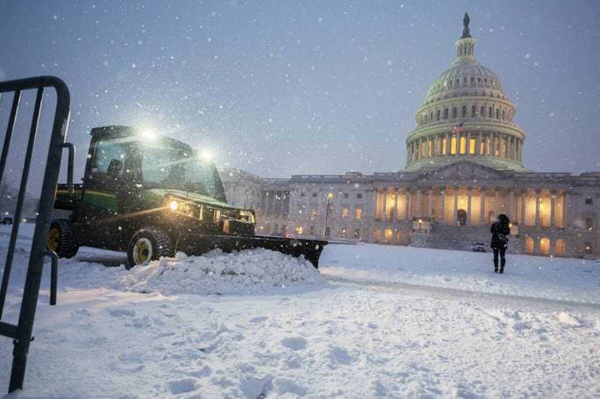 A snowplow clears a path outside the U.S. Capitol during a snowstorm in Washington, D.C., on Jan. 16. (Craig Hudson for The Washington Post)