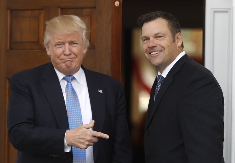 President-elect Donald Trump greets Kansas Secretary of State, Kris Kobach, as he arrive at the Trump National Golf Club Bedminster clubhouse. (AP Photo/Carolyn Kaster)</p>  