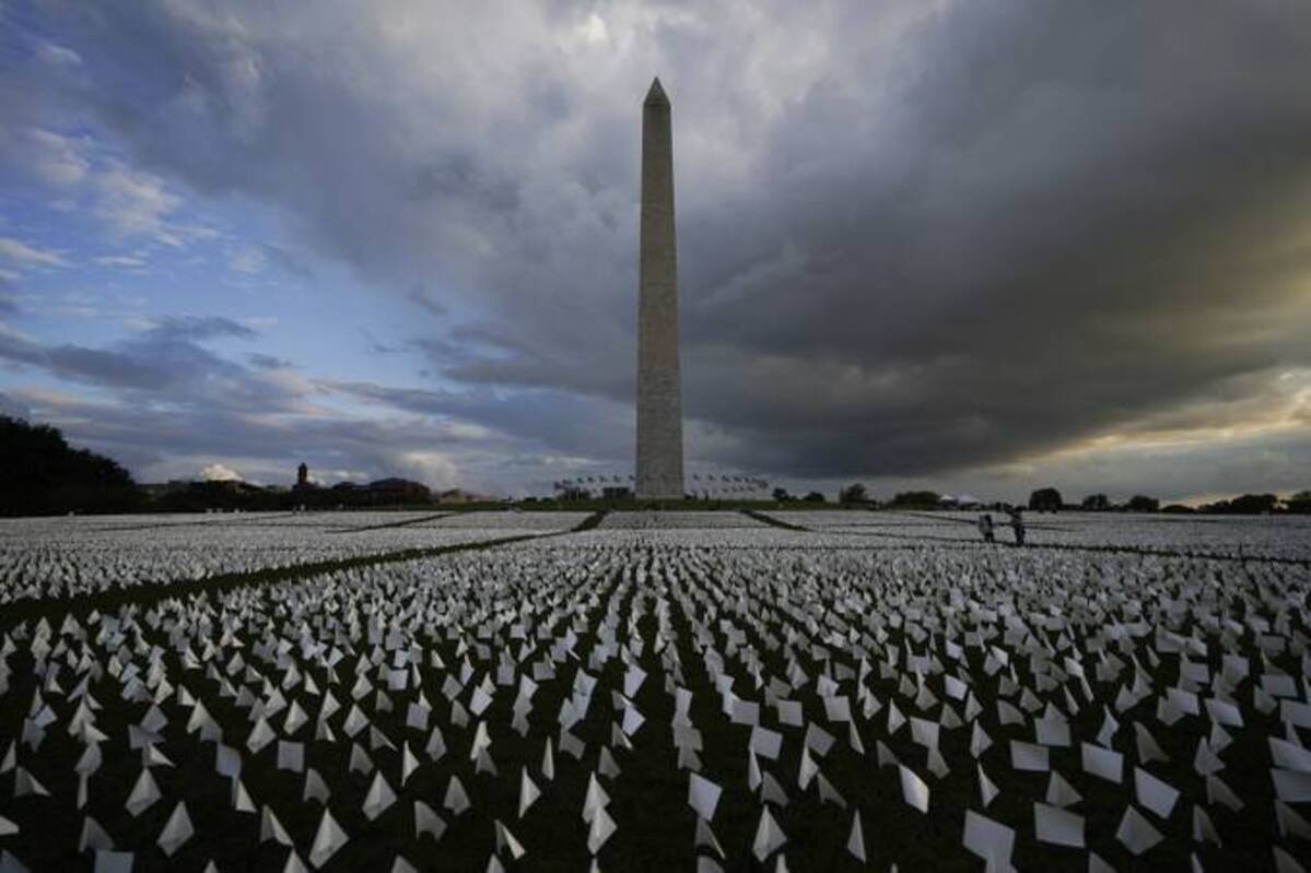 People look at white flags that are part of artist Suzanne Brennan Firstenberg's temporary art installation, 
