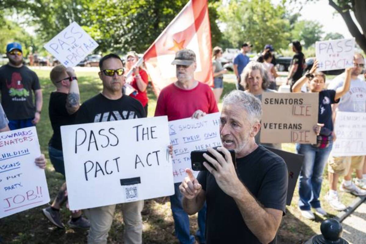 Jon Stewart speaks with veterans and activists outside the Capitol on Tuesday. (Jabin Botsford/The Washington Post)