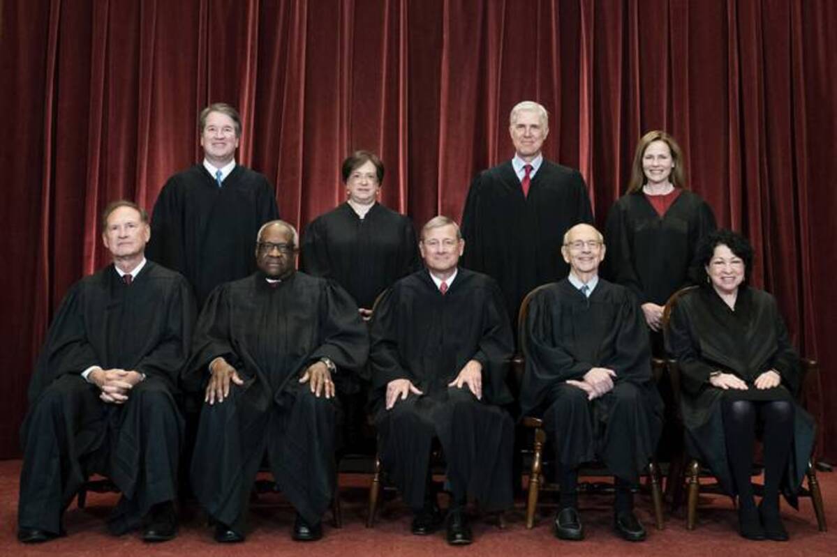 Members of the Supreme Court pose for a group photo at the Supreme Court in Washington on April 23, 2021. (Erin Schaff/the New York Times via AP)